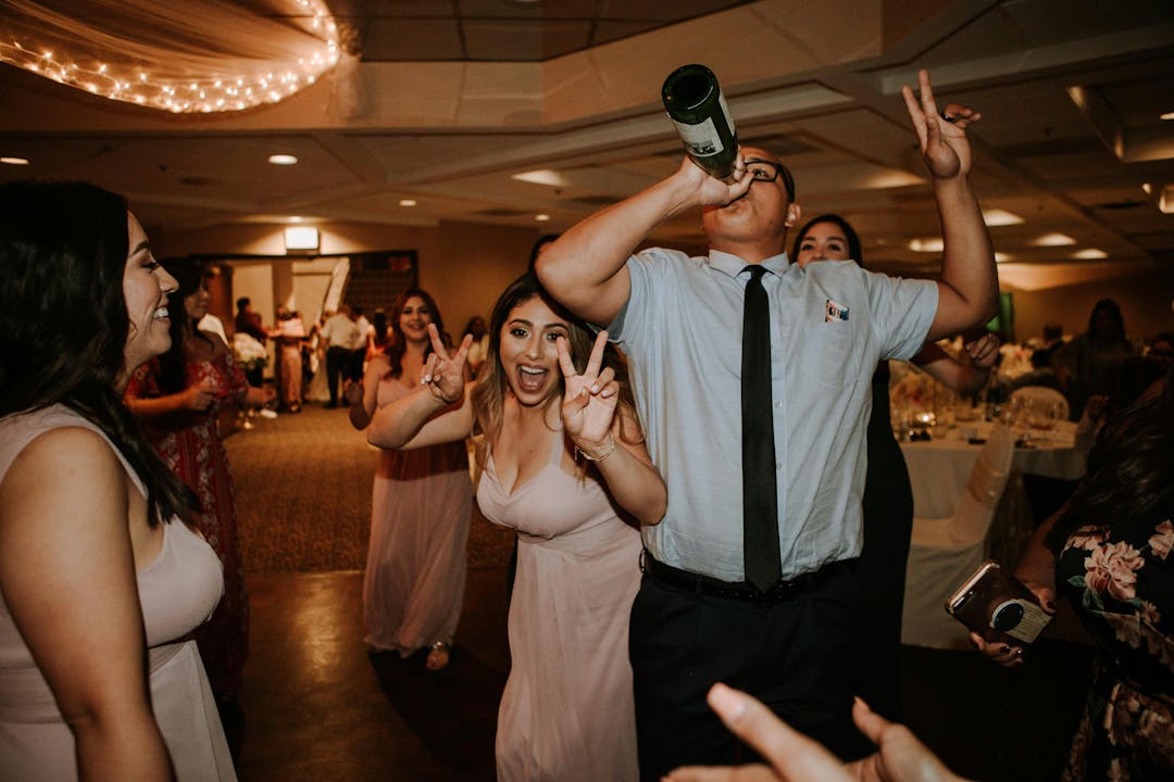 people at a wedding drinking and having a good time